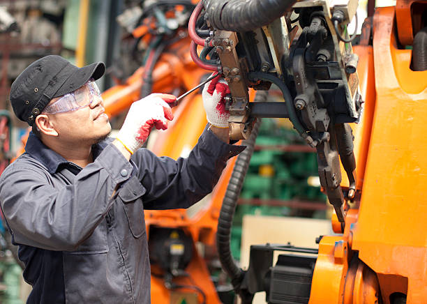 Petrol pump mechanic working on a dispenser